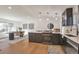 Open-concept kitchen with dark cabinets, quartz countertops, stainless steel appliances, and eat-in dining area at 3733 W 97Th Ave, Westminster, CO 80031