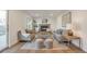 Bright living room with a brick fireplace, wood floors, and modern furniture at 3733 W 97Th Ave, Westminster, CO 80031