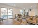 Bright living room with brick fireplace, wood floors, and access to backyard through sliding doors at 3733 W 97Th Ave, Westminster, CO 80031