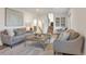 Cozy living room with comfortable seating, layered rug, a staircase and plenty of natural light at 3733 W 97Th Ave, Westminster, CO 80031