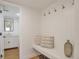 Convenient mudroom with built-in bench, hooks, and decor, seamlessly connects to a bathroom at 3733 W 97Th Ave, Westminster, CO 80031