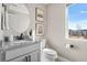 Half bathroom featuring granite countertops, a modern sink and faucet, decor, and a window for natural light at 4355 Cyan Cir # E, Castle Rock, CO 80109