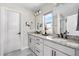 Double vanity bathroom featuring granite countertops, a modern sink and faucet, decor, and a window for natural light at 4355 Cyan Cir # E, Castle Rock, CO 80109