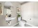 Powder room with modern fixtures, including a wall-mounted sink and a low-flow toilet at 4355 Cyan Cir # E, Castle Rock, CO 80109