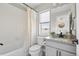 Bright bathroom featuring a shower-tub combo, a modern vanity, and a window providing natural light at 4355 Cyan Cir # E, Castle Rock, CO 80109