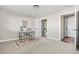 Well-lit room featuring a desk, a decorative rug, and doorways leading to other areas of the house at 4355 Cyan Cir # E, Castle Rock, CO 80109