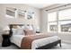 Bedroom with neutral paint, carpet, a modern bed frame, side tables and lamps and large windows at 4355 Cyan Cir # E, Castle Rock, CO 80109