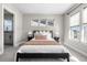 Bedroom with neutral paint, carpet, a modern bed frame, side tables and lamps and large windows at 4355 Cyan Cir # E, Castle Rock, CO 80109