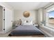Cozy bedroom with a neutral color palette, stylish decor, and natural light from the window at 4355 Cyan Cir # E, Castle Rock, CO 80109