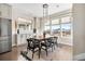 Bright dining room with a wood table, modern lighting fixtures, and three windows with neighborhood views at 4355 Cyan Cir # E, Castle Rock, CO 80109