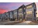 Modern townhomes with a combination of siding and stone accents, garages, and well-maintained landscaping at 4355 Cyan Cir # E, Castle Rock, CO 80109