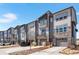 Stylish townhomes with stone facade, private balconies, and attractive landscaping with driveways for parking at 4355 Cyan Cir # E, Castle Rock, CO 80109