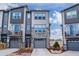 Modern townhome with stone accents, gray siding, attached garages, and small private balcony in a contemporary design at 4355 Cyan Cir # E, Castle Rock, CO 80109