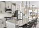 Island kitchen with granite countertops, stainless steel appliances, bar seating, and an adjacent dining area at 4355 Cyan Cir # E, Castle Rock, CO 80109
