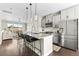 Open kitchen features a large island with seating, stainless steel appliances, and hardwood floors at 4355 Cyan Cir # E, Castle Rock, CO 80109