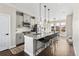 Modern kitchen with gray cabinets, granite countertops, a large island with seating, and stainless steel appliances at 4355 Cyan Cir # E, Castle Rock, CO 80109