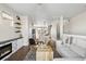 Open-concept living room with hardwood floors, fireplace, and kitchen view, ideal for entertaining and relaxing at 4355 Cyan Cir # E, Castle Rock, CO 80109