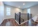 Upstairs hallway with wood flooring and a window at 3918 S Rome Ct, Aurora, CO 80018