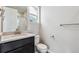 Modern bathroom featuring a dark vanity with white countertop and a glass-enclosed shower at 2548 Lupton Ln, Lafayette, CO 80026
