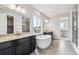 Luxurious bathroom with a soaking tub, dual vanities, and a separate glass-enclosed shower at 2548 Lupton Ln, Lafayette, CO 80026