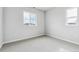 Neutral bedroom with carpeted floor, two windows, and white trim at 2548 Lupton Ln, Lafayette, CO 80026