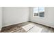 Bright bedroom with wood-look flooring and a large window offering natural light and community views at 2548 Lupton Ln, Lafayette, CO 80026