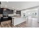 Modern kitchen boasts dark cabinetry, a large center island, stainless steel appliances, and open layout at 2548 Lupton Ln, Lafayette, CO 80026