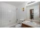 Full bathroom with white tiled shower/tub and classic vanity at 14171 E Jewell Ave # 203, Aurora, CO 80012