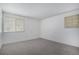 Bright bedroom with neutral carpet and natural light from two windows at 14171 E Jewell Ave # 203, Aurora, CO 80012