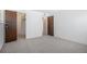Neutral carpeted bedroom with double closet and access to other rooms at 14171 E Jewell Ave # 203, Aurora, CO 80012