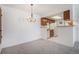 Bright dining area adjacent to the kitchen, featuring a stylish chandelier at 14171 E Jewell Ave # 203, Aurora, CO 80012