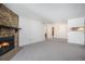 Spacious living room with a stone fireplace and adjacent dining area at 14171 E Jewell Ave # 203, Aurora, CO 80012