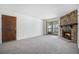 Cozy living room featuring a beautiful stone fireplace and sliding glass doors at 14171 E Jewell Ave # 203, Aurora, CO 80012
