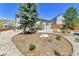 Landscaped backyard features stone patio and lush greenery at 1034 Halfmoon Dr, Castle Rock, CO 80104