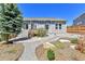 Backyard with gravel landscaping, patio, and stairs leading to the back door at 1034 Halfmoon Dr, Castle Rock, CO 80104