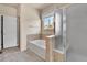 Clean bathroom featuring a tub, separate shower, and neutral tile surround at 1034 Halfmoon Dr, Castle Rock, CO 80104