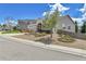 Inviting home with landscaped front yard, beautiful tree, and cozy porch at 1034 Halfmoon Dr, Castle Rock, CO 80104