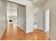Bright hallway with hardwood floors leading to the carpeted living room with fireplace at 1034 Halfmoon Dr, Castle Rock, CO 80104