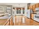 Bright kitchen area featuring hardwood floors, a bay window, and stainless steel appliances at 1034 Halfmoon Dr, Castle Rock, CO 80104