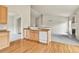 Open-concept kitchen with hardwood floors, modern appliances, and seamless flow to the living area at 1034 Halfmoon Dr, Castle Rock, CO 80104