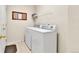 Functional laundry room with white appliances and storage shelves at 1034 Halfmoon Dr, Castle Rock, CO 80104