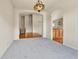 Inviting living room featuring an elegant chandelier and archways to other rooms at 1034 Halfmoon Dr, Castle Rock, CO 80104