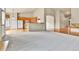 Spacious living room with open floor plan leading to kitchen and hardwood floors at 1034 Halfmoon Dr, Castle Rock, CO 80104