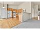 Open-concept kitchen with hardwood floors transitioning to carpet in living area at 1034 Halfmoon Dr, Castle Rock, CO 80104