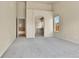 Open main bedroom layout leads to ensuite bath, offers neutral walls and carpeted floors at 1034 Halfmoon Dr, Castle Rock, CO 80104