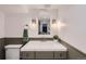 Well-lit bathroom with a decorative mirror, modern vanity, and a neatly folded towel at 108 W Byers Pl # 106, Denver, CO 80223