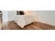 Comfortable bedroom featuring hardwood floors, soft bedding, and stylish throw pillows at 108 W Byers Pl # 106, Denver, CO 80223