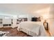 Cozy bedroom featuring wood floors and a white quilted bed at 108 W Byers Pl # 106, Denver, CO 80223