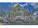 Historic Byers School No. 1 features detailed brickwork and symmetrical design, framed by mature trees at 108 W Byers Pl # 106, Denver, CO 80223