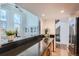 Modern kitchen with black countertops, stainless steel appliances, and an open layout to the living area at 108 W Byers Pl # 106, Denver, CO 80223